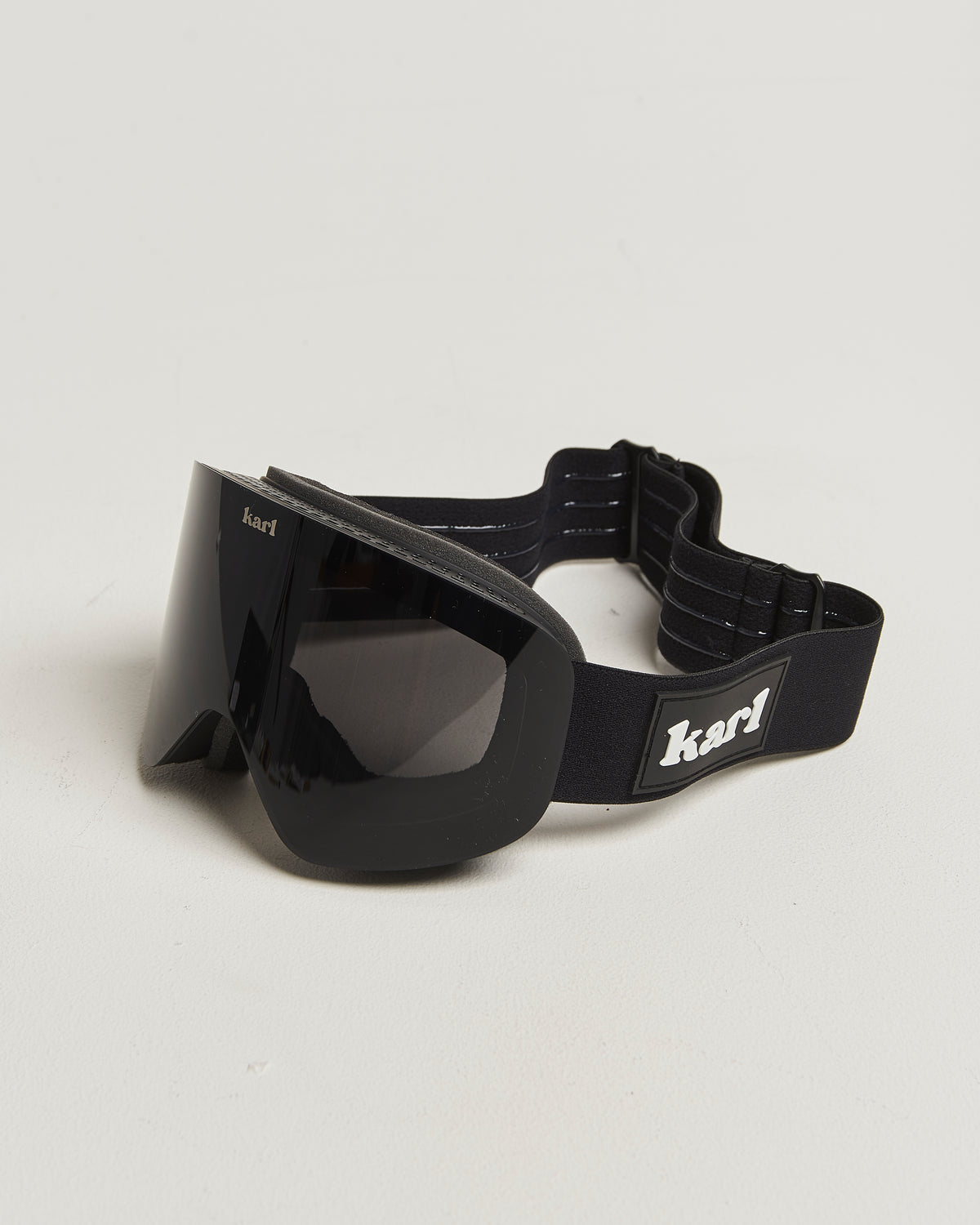 Black Karl Straightliner goggles with a dark lens and branded strap.